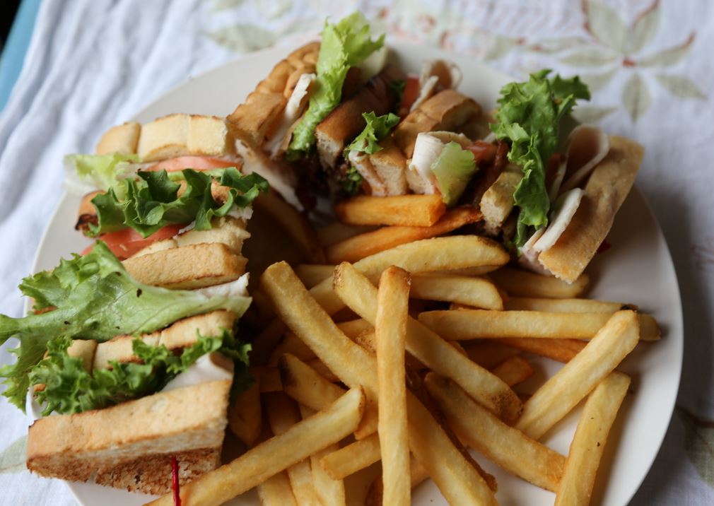 freshly toasted Club Sandwich with fries